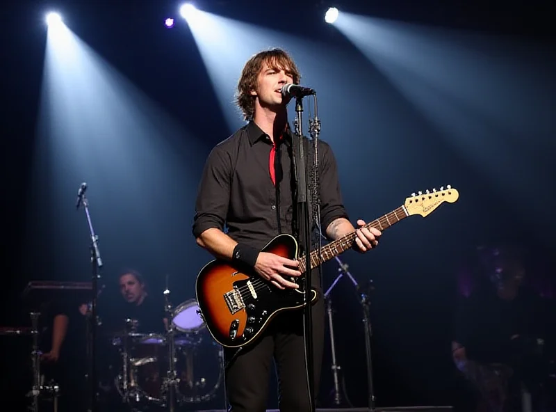A paparazzi style shot of Danny Jones performing on stage with his band McFly. He is singing into a microphone and playing guitar.