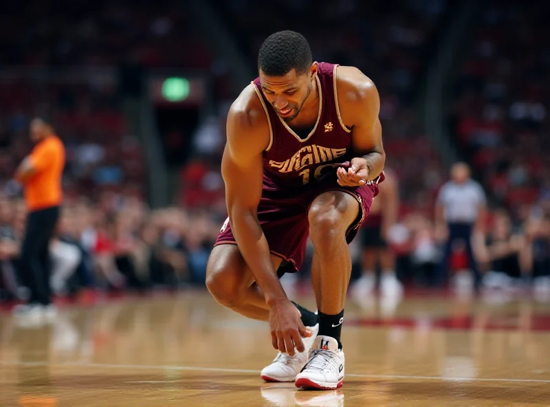 A basketball player grimacing in pain while holding their ankle during a game.